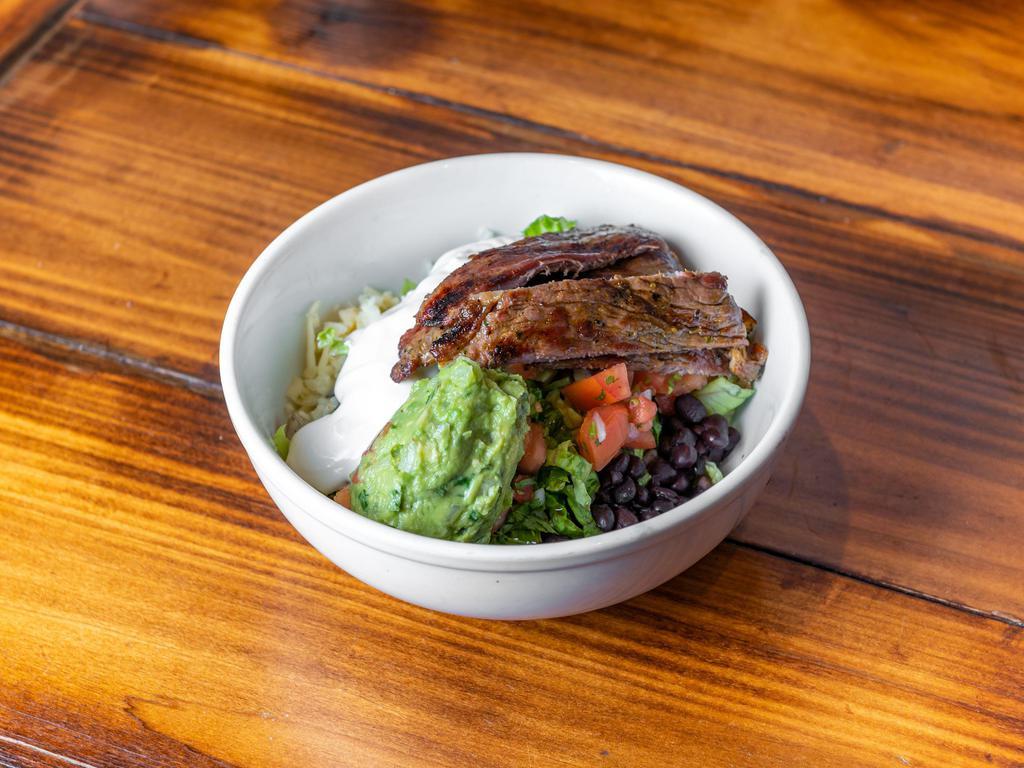 Carne Asada Rice Bowl · Grill top sirloin steak with Mexican rice & Beans, Jack cheese, Pico De Gallo, Lettuce, and Sour cream on top with Salsa Verde on the side.