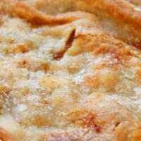 Peach Cobbler · A traditional cobbler filled with ripe peaches, seasoned with spices between 2 buttery crusts.