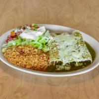 Verdes Enchilada · 3 chicken enchiladas topped with green sauce and served with rice, lettuce, sour cream and p...