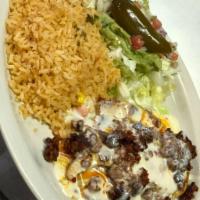 Choripollo · Grilled chicken breast topped with Mexican sausage and melted cheese. Served with lettuce, g...