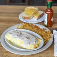 Chicken Fried Steak Omelet · Bite sized pieces of our chicken fried steak folded into fluffy eggs with cheddar cheese and...
