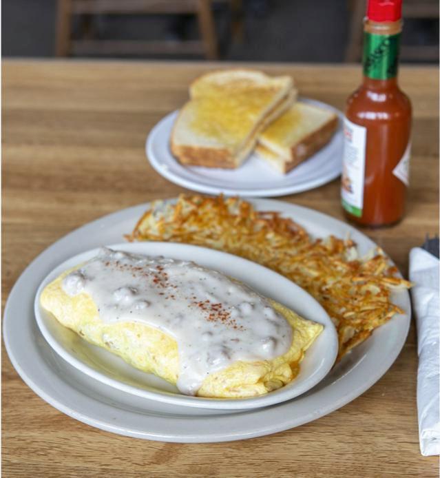 Chicken Fried Steak Omelet · Bite sized pieces of our chicken fried steak folded into fluffy eggs with cheddar cheese and covered with country sausage gravy. 