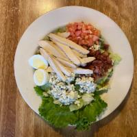 Cobb Salad · Crisp greens, tender grilled chicken breast, bacon, tomatoes, crumbled bleu cheese, and a ha...
