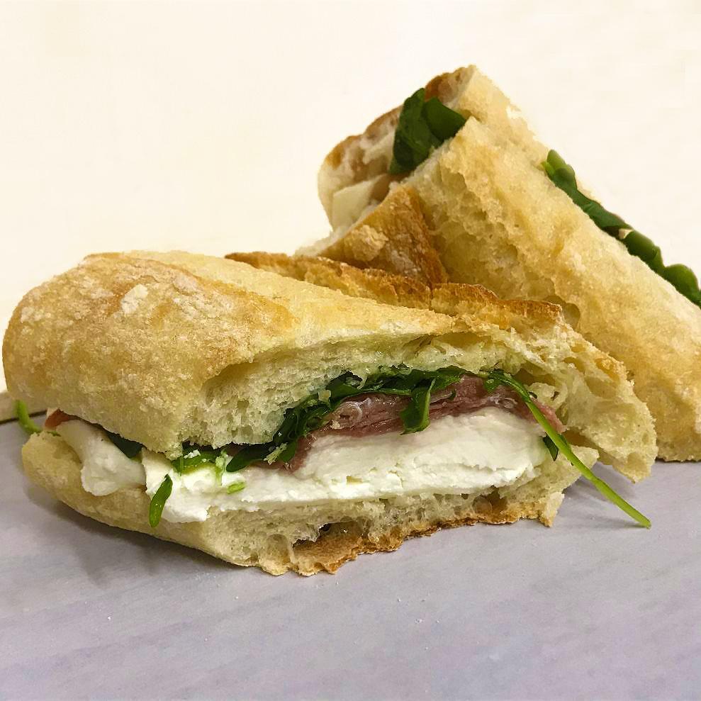 Prosciutto and Mozzarella · Prosciutto, fresh mozzarella, arugula and balsamic on a rustic baguette. [Allergens: Wheat, Milk] Handcrafted daily, no substitutions available. Dressing not available on the side. 