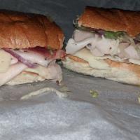29. Turkey Club Sandwich · Fresh turkey topped with crisp turkey bacon, provolone, and Swiss cheese, lettuce, tomatoes,...