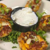 Loaded Spuds · Potato Skins topped with Monterey Jack and Cheddar, bacon bits and fresh chives.  Served wit...