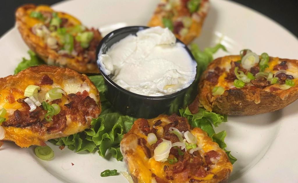 Loaded Spuds · Potato Skins topped with Monterey Jack and Cheddar, bacon bits and fresh chives.  Served with sour cream or ranch.  Add bleu cheese dipping sauce or extra ranch for $.50.