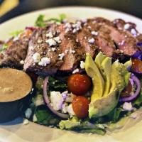 Casablanca Steak Salad · New York steak, spring mix, red onions, Kalamata olives, bleu cheese crumbles, roasted red p...