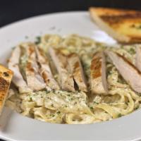 Fettuccini Alfredo  · Fettuccini pasta tossed in creamy Parmesan sauce with grilled chicken. Served with garlic br...