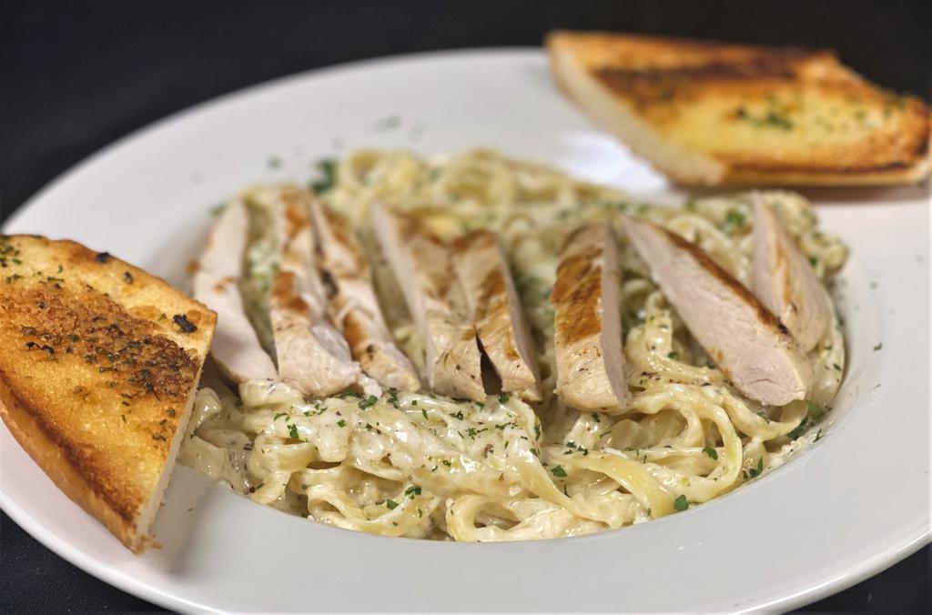 Fettuccini Alfredo  · Fettuccini pasta tossed in creamy Parmesan sauce with grilled chicken. Served with garlic bread.