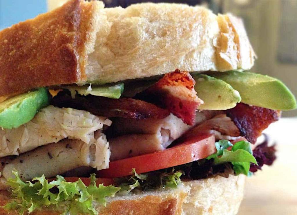 Turkey Bacon Avocado Sandwich · Turkey, peppered bacon, avocado, lettuce, tomatoes, and mayonnaise on a whole wheat bread.