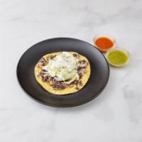 Simples Tostada · Includes beans, lettuce, sour cream and cotija cheese.