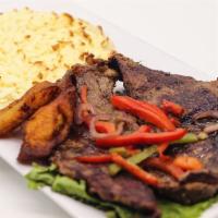 Carne Asada con Arepa · Grilled steak with corn cake and cheese.