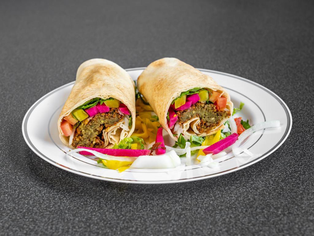 Falafel Wrap · Deep-fried chickpeas rolled with tomato, lettuce, pickle, hummus and tahini sauce wrapped in saji bread
