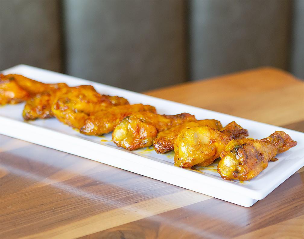 Mango Habanero Wings · Mary's natural chicken wings tossed in spicy mango and habanero sauce.