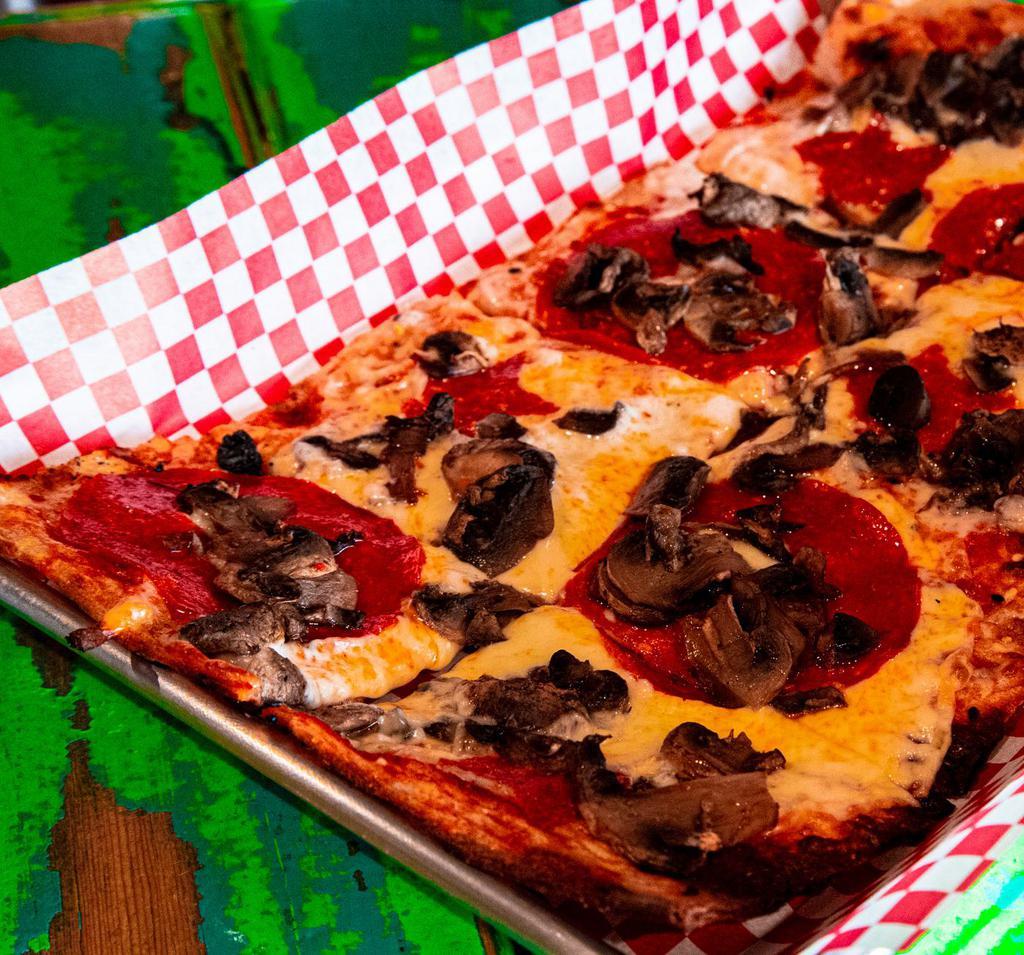 Pam Pizza · Oversized pepperoni and baked mushrooms.
