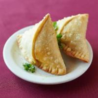 Vegetable Samosa · Crisp Pastry filled with Potato, peas, spices and deep fried.