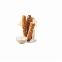 Dairy Queen Bakes Pretzel Sticks with Zesty Queso · Soft pretzel sticks, served hot from the oven, topped with salt and served with warm zesty q...