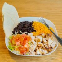 Latin Chops · Chopped grilled chicken breast, served on rice, with black beans, lettuce, tomatoes, and pita.