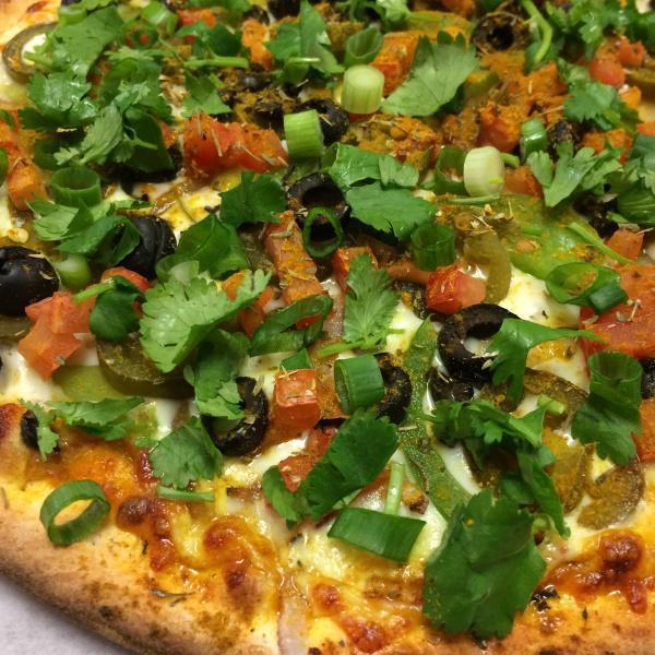Curry Veggie Pizza · Curry sauce, mozzarella, green bell peppers, black olives, red onions, jalapenos, diced tomato, mushroom, fresh cilantro and green onions.