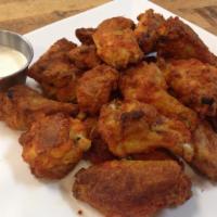 Buffalo Wings · Over baked Buffalo wings with ranch on the side.