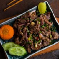 Beef Namtok · Sliced, grilled flank steak, red onions, green onions, cilantro and toasted rice powder in a...
