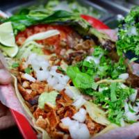 Tacos al Pastor · Soft warm corn tortilla filled with marinated chopped pork loin with fresh cilantro, onions ...