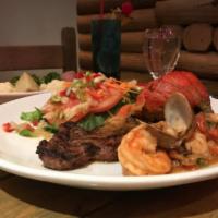 Tsunami · Tender sirloin steak topped with tilapia fillet and shrimp. Served with steamed vegetables.