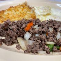 Huevos con Picadillo · 2 farm-fresh eggs prepared with ground beef, pepper, tomatoes, and onions. Served with hash ...