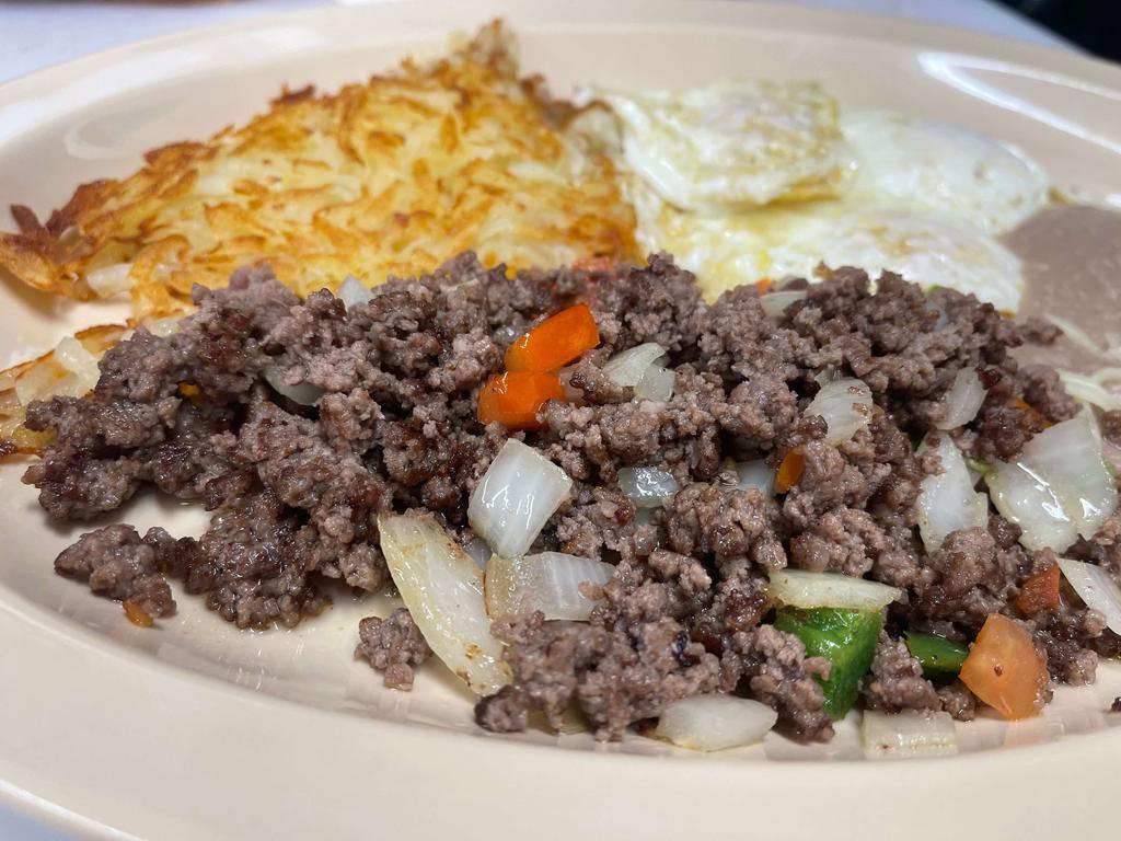 Huevos con Picadillo · 2 farm-fresh eggs prepared with ground beef, pepper, tomatoes, and onions. Served with hash browns, refried, and a flour tortilla.