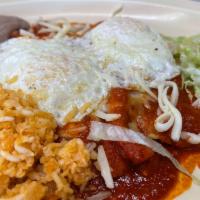 Enchiladas Montadas · 3 cheese enchiladas topped with 2 farm-fresh eggs. Served with rice, refried beans, and a fl...