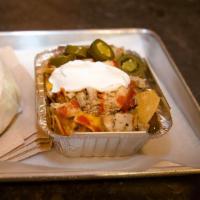 Ballpark Nachos -chicken · Tortilla chips on a bed of beans, topped with chicken, nacho cheese sauce, sour cream, mild ...