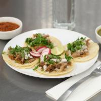 Carnitas Taco · Braised pork. Served with cilantro and onion.