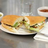 Al Pastor Torta · Seasoned pork. Served with beans, mayonnaise, beans, lettuce, Mexican cheese, avocado, pickl...