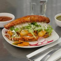 Pambazo Romeros Torta · Torta dipped in red chili sauce. Served with beans, potato, carrot, lettuce, sour cream, che...