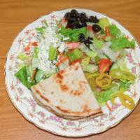 Greek Salad · Cucumber, tomatoes, lettuce with feta cheese and Greek vinaigrette with pita bread.

