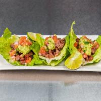 Steak Tacos  · Three Tacos Topped with Pico De Gallo, Lettuce & Guacamole 