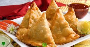 Triangles of Love  · Crispy fried turnovers filled with potatoes, green peas and spices.