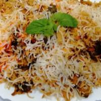 Chicken Dum Biryani · Long grain basmati rice cooked with chicken, tossed herbs, and exotic spices and garnished w...