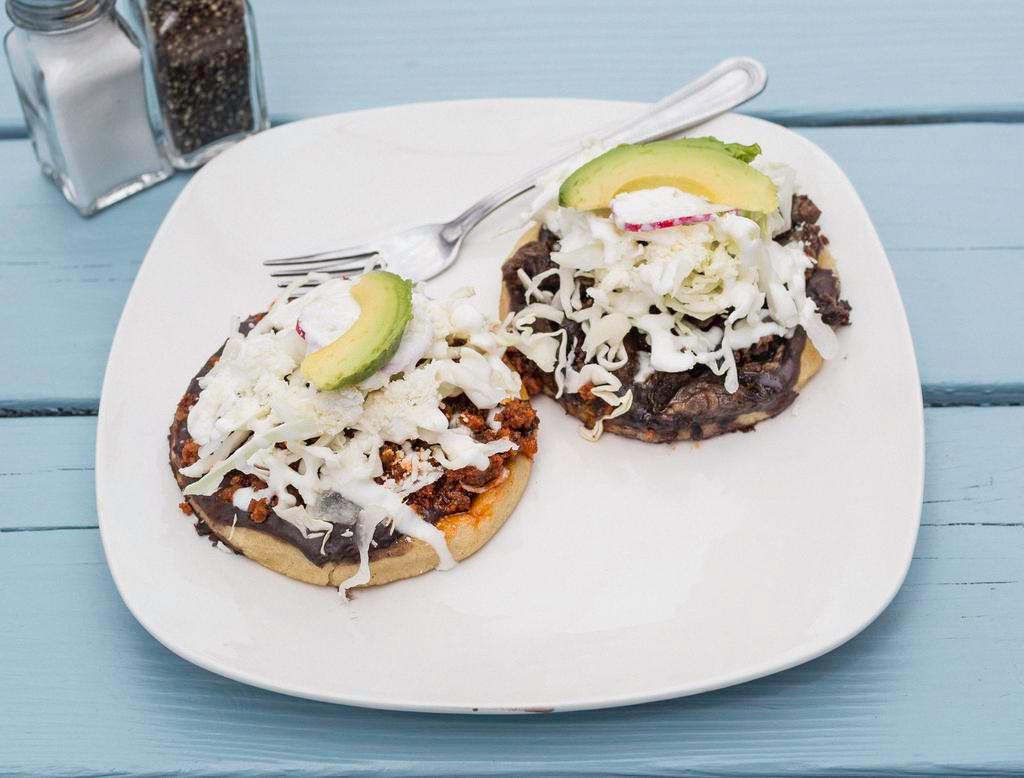 Roasted Vegetables Sope · Fresh home-made, gluten free corn masa dough. With beans, sour cream, cotija cheese, green sauce, radishes, avocado, onion and cabbage.