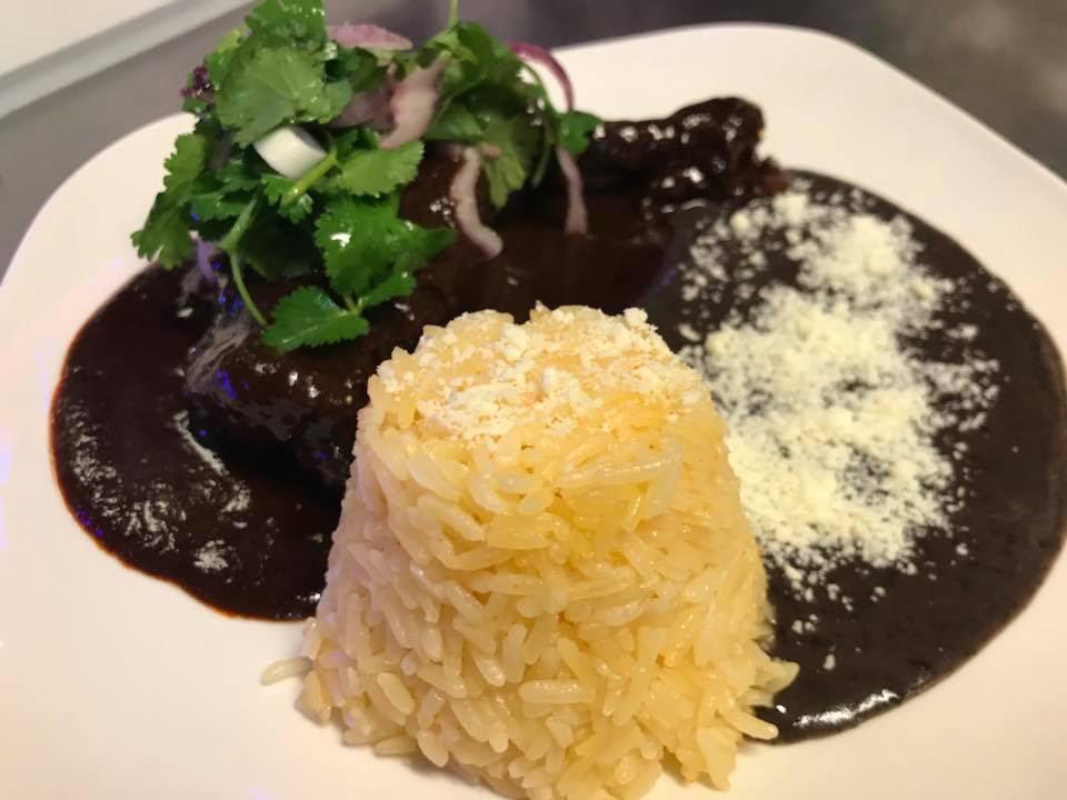 Chicken in Mole Platillo · Variety of authentic Mexican dishes with beans, rice and fresh home-made, gluten free corn tortillas.