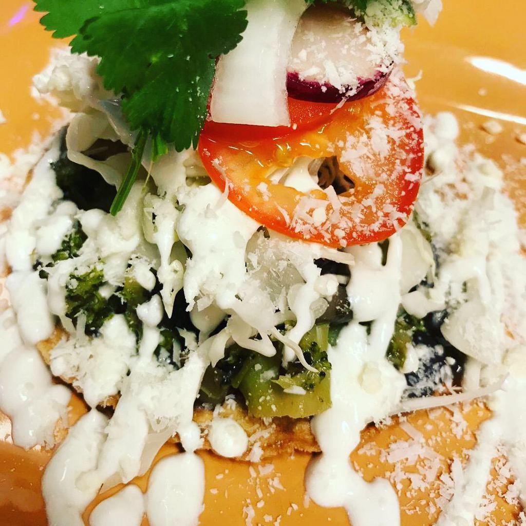 Vegetable Tostada · Fried corn tortilla with vegetable. Served with a mixture of cabbage, onion, tomato, radishes, avocado, sour cream and cotija cheese.