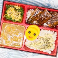 Eel Bento Box · Served with braised eel, curry (mild), seaweed salad, corn, radish, rice. Contains sesame seed