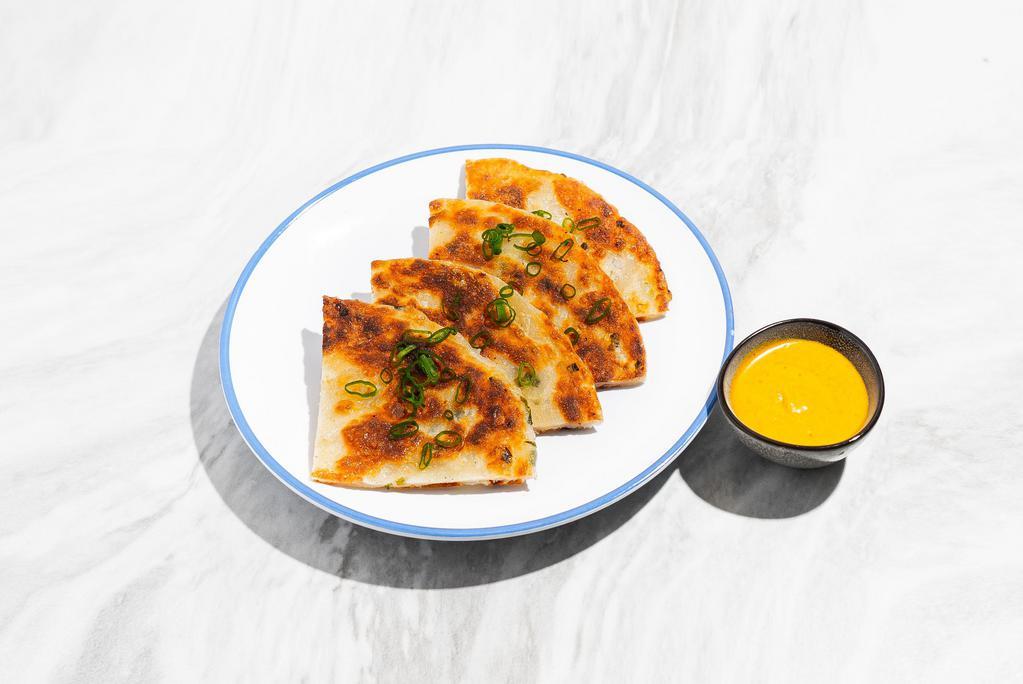 Scallion Pancake with Curry Sauce · Pan fried Chinese savory flat bread folded with scallions.
Served with yellow curry sauce.
Contains: Tree Nuts, Gluten, Eggs, Soy