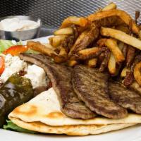Beef Gyro · Pita bread, Greek salad and french fries.