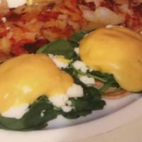 Florentine Benedict · Poached eggs, feta cheese, and sauteed spinach on an English muffin topped with hollandaise ...