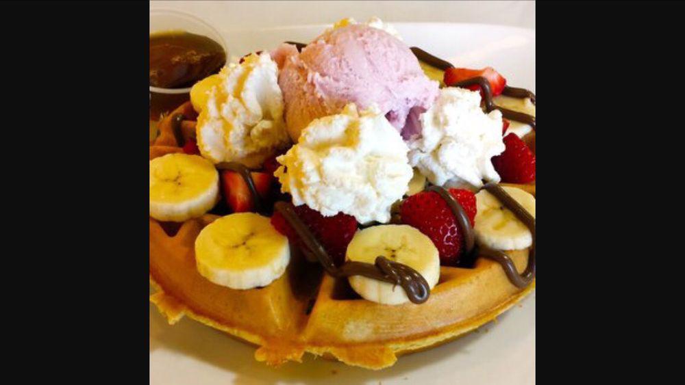 Waffle Sundae · Belgian waffle topped with three (3) scoops of ice cream. Served with syrup and whipped cream.
