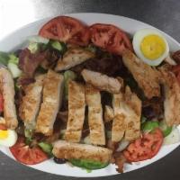 Cobb Salad · Lettuce, tomato, cucumber, green pepper, black olives, hard boiled egg and bacon topped with...