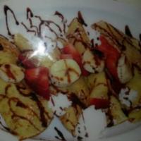 Banana and Strawberry Crêpes · Stuffed with fresh bananas and strawberries. Topped with powdered sugar and whipped cream. C...