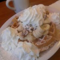 Belgian Waffle · Crispy and sprinkled with powdered sugar. Served with syrup and whipped butter.